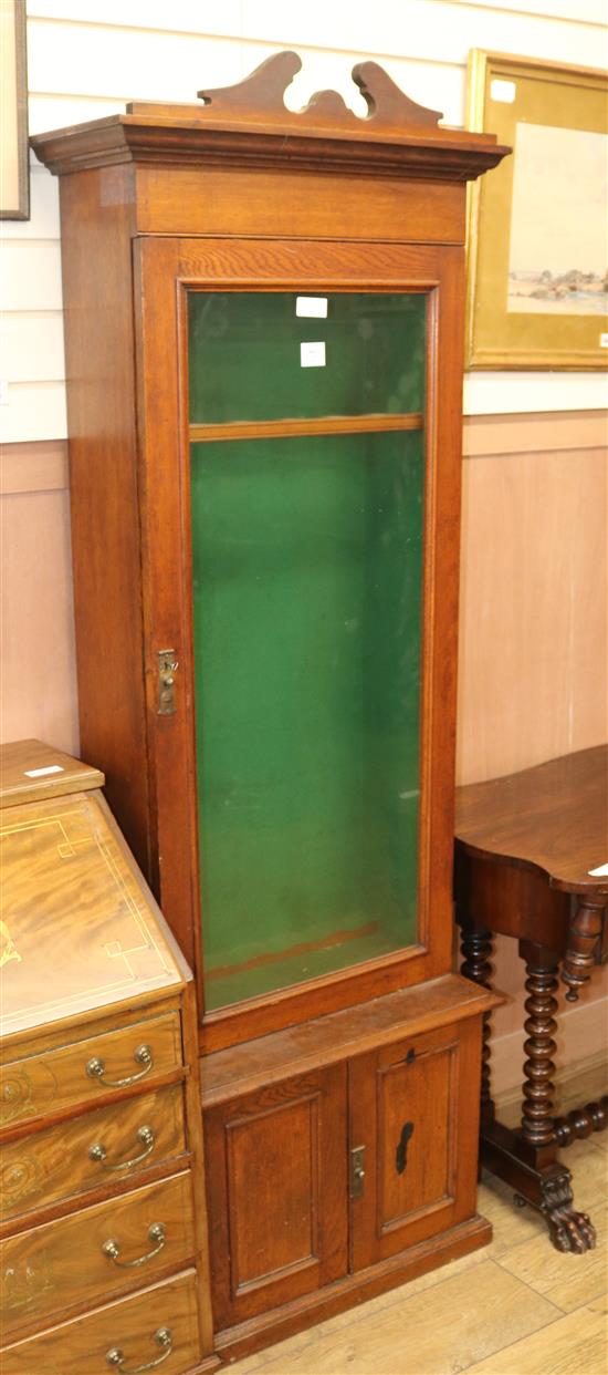 A Continental oak gun cabinet, H.194cm